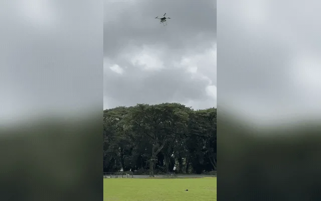 A custom UAV releasing its payload during an outdoor hardware test